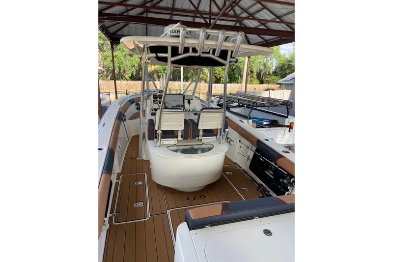  Yacht Photos Pics 2010 Pursuit C 280 Center Console boat with sleek design and spacious deck under a canopy.