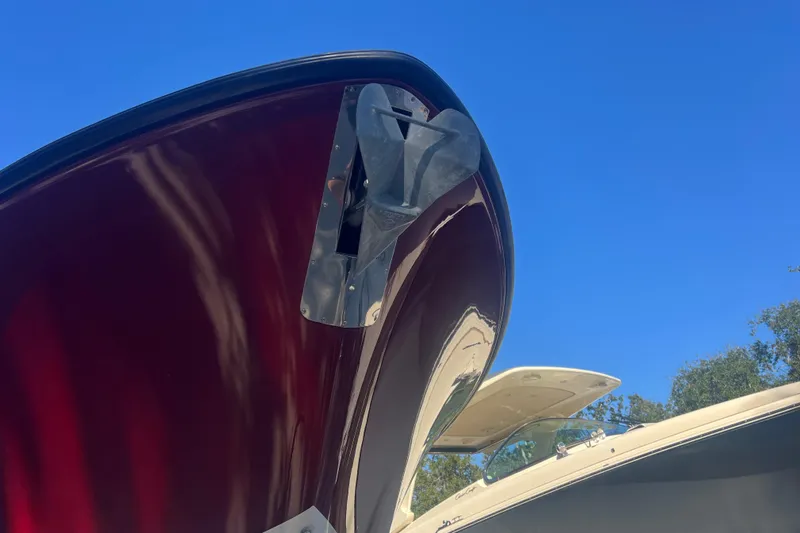  Yacht Photos Pics 2010 Pursuit C 280 Center Console boat with sleek red hull against clear blue sky.