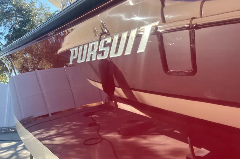  Yacht Photos Pics 2010 Pursuit C 280 Center Console boat with reflective maroon finish.