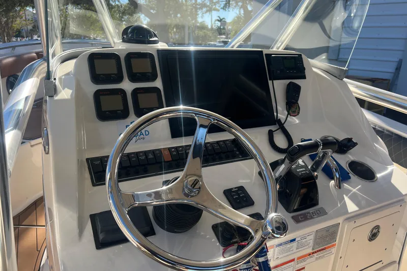  Yacht Photos Pics 2010 Pursuit C 280 Center Console boat dashboard with steering wheel and navigation controls.