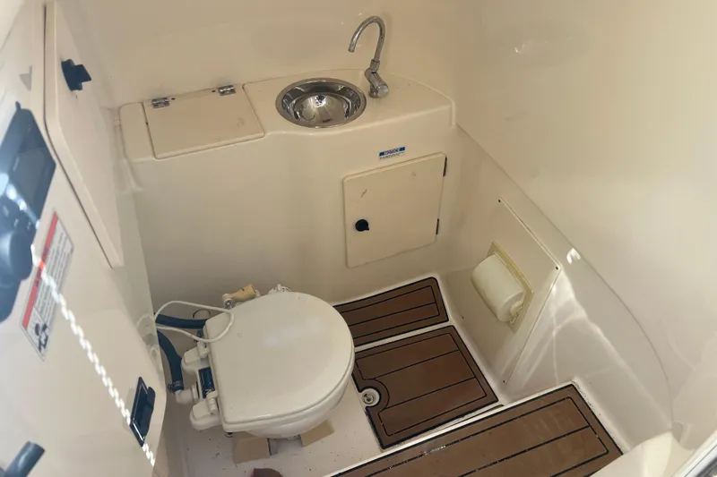  Yacht Photos Pics 2010 Pursuit C 280 Center Console boat bathroom with sink and toilet.