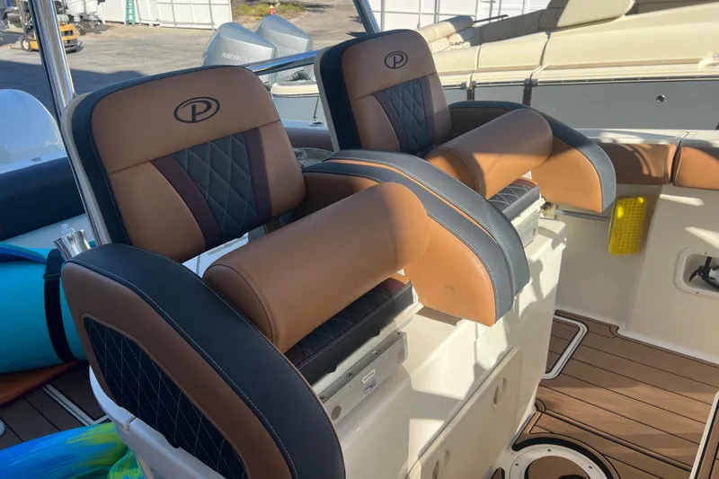  Yacht Photos Pics 2010 Pursuit C 280 Center Console boat seats with brown and black leather upholstery.