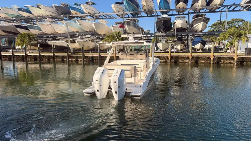  Yacht Photos Pics 2023 Tiara Sport 34 LS boat in water near boat storage.