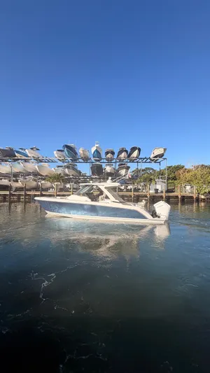  Yacht Photos Pics 2023 Tiara Sport 34 LS boat on water near a marina.