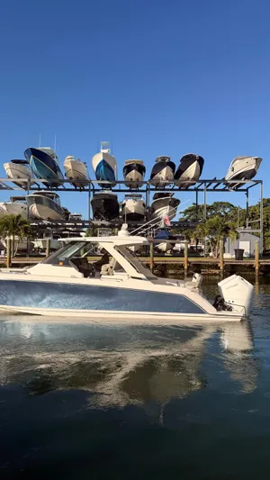 Yacht Photos Pics Tiara Sport 34 LS 2023 boat in front of a marina boat rack.