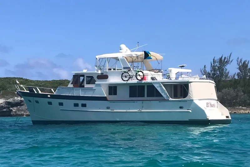 El Sueno Yacht Photos Pics Grand Alaskan 60 Pilothouse yacht, 1998 model, anchored in clear blue waters.
