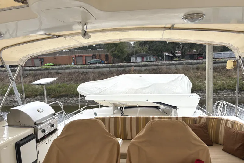 El Sueno Yacht Photos Pics 1998 Grand Alaskan 60 Pilothouse yacht deck with seating, grill, and covered equipment.