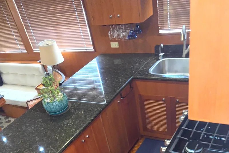 El Sueno Yacht Photos Pics Luxurious kitchen interior of 1998 Grand Alaskan 60 Pilothouse yacht with granite countertops.