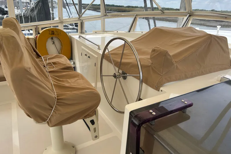 El Sueno Yacht Photos Pics Pilothouse of 1998 Grand Alaskan 60, featuring covered seats and steering wheel.