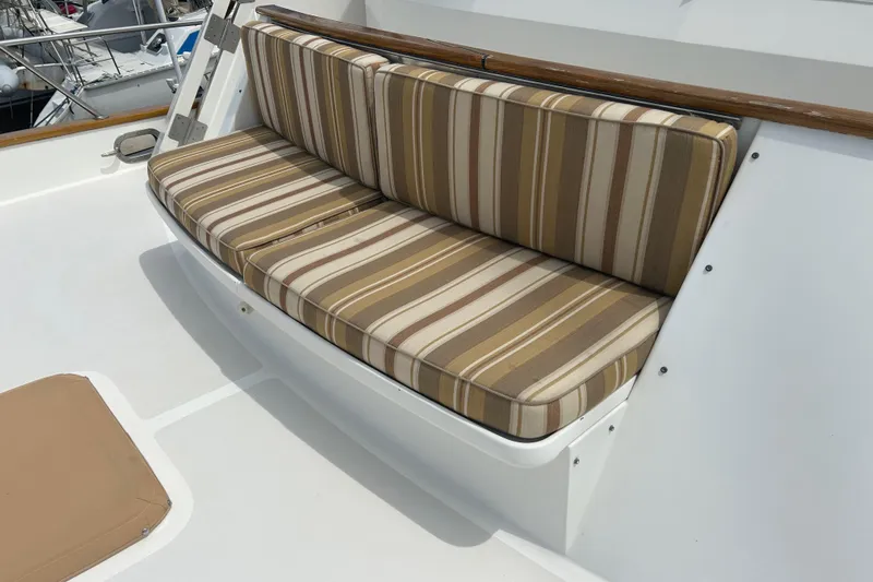 El Sueno Yacht Photos Pics Striped cushioned seating on 1998 Grand Alaskan 60 Pilothouse yacht deck.