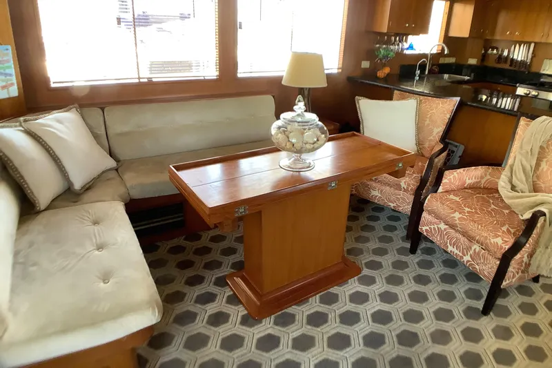 El Sueno Yacht Photos Pics Luxurious 1998 Grand Alaskan 60 Pilothouse interior with elegant seating and wooden table.