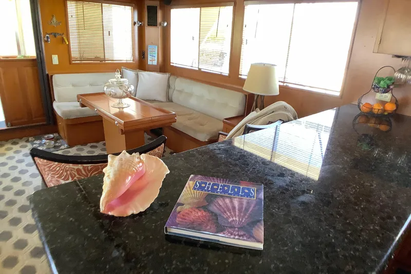 El Sueno Yacht Photos Pics Interior of 1998 Grand Alaskan 60 Pilothouse with cozy seating and decorative elements.