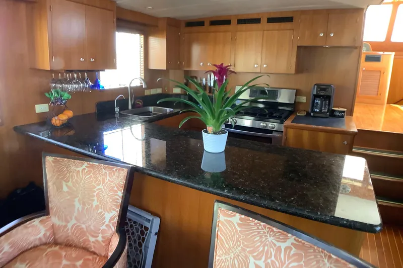 El Sueno Yacht Photos Pics Luxurious kitchen interior of 1998 Grand Alaskan 60 Pilothouse yacht with granite countertops.
