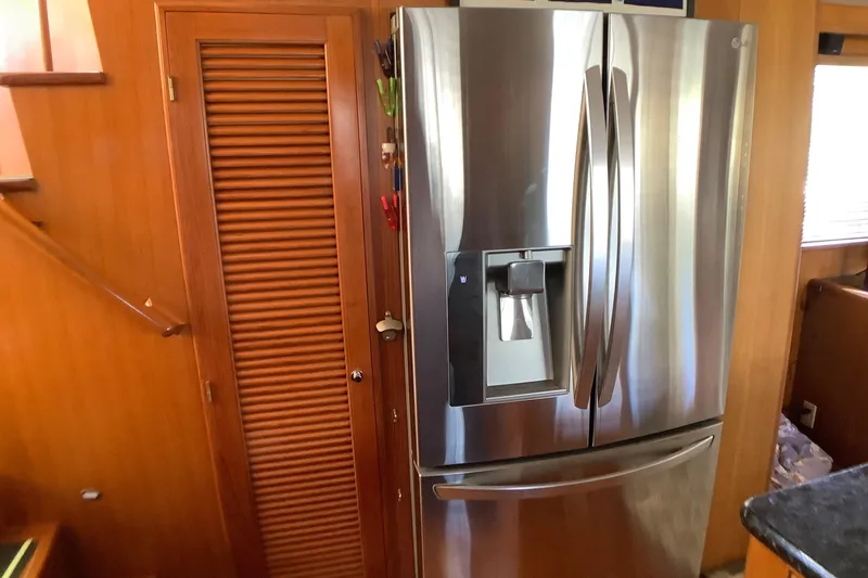 El Sueno Yacht Photos Pics Stainless steel refrigerator in 1998 Grand Alaskan 60 Pilothouse interior.
