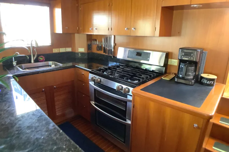 El Sueno Yacht Photos Pics Kitchen area of 1998 Grand Alaskan 60 Pilothouse with stove, sink, and coffee maker.
