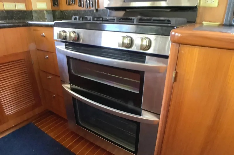 El Sueno Yacht Photos Pics Stainless steel oven in 1998 Grand Alaskan 60 Pilothouse yacht kitchen.