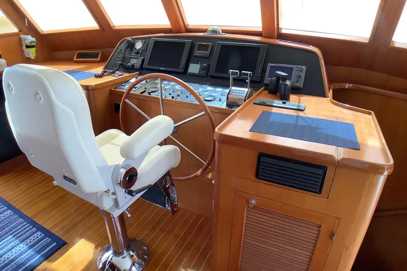 El Sueno Yacht Photos Pics Pilothouse of 1998 Grand Alaskan 60, featuring a steering wheel and navigation controls.