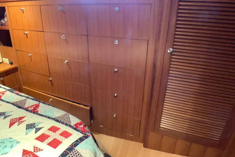 El Sueno Yacht Photos Pics Wooden cabin interior of 1998 Grand Alaskan 60 Pilothouse with quilted bedspread.