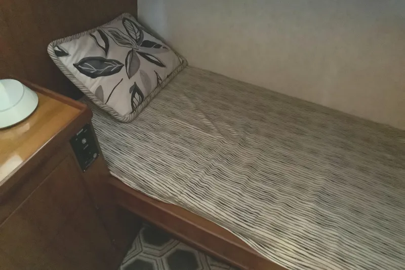 El Sueno Yacht Photos Pics Cozy cabin bed in 1998 Grand Alaskan 60 Pilothouse yacht with floral pillow.