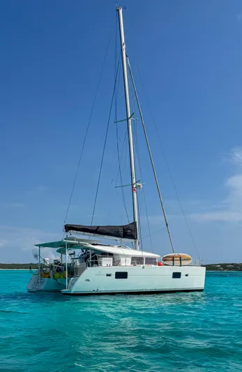 Dao And Out Yacht Photos Pics Sailing catamaran Lagoon 400, 2011 model, anchored in clear turquoise waters.