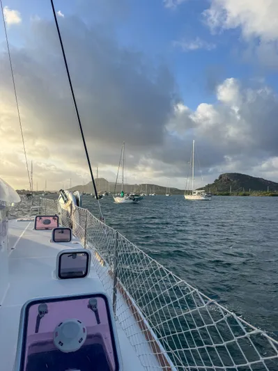 Dao And Out Yacht Photos Pics Sailing on a 2011 Lagoon 400 catamaran in a scenic bay with moored boats.