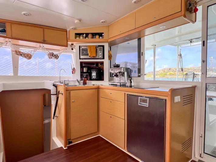 Dao And Out Yacht Photos Pics Interior of 2011 Lagoon 400 catamaran kitchen with modern appliances and wooden cabinetry.