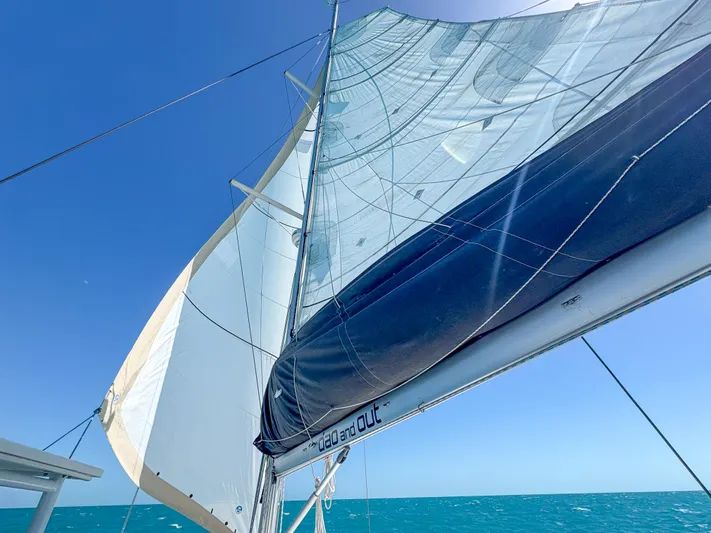 Dao And Out Yacht Photos Pics Sailing on a 2011 Lagoon 400 catamaran with full sails against a clear blue sky.