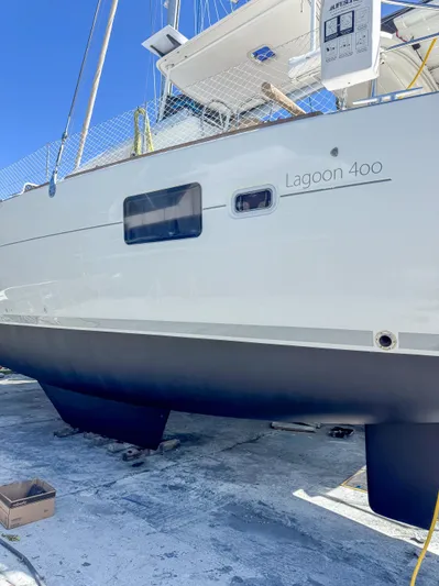 Dao And Out Yacht Photos Pics 2011 Lagoon 400 catamaran on dry dock, showcasing sleek hull design.