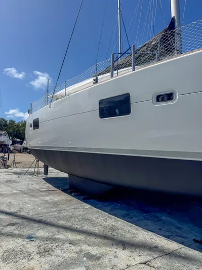 Dao And Out Yacht Photos Pics 2011 Lagoon 400 catamaran on dry dock under clear blue sky.
