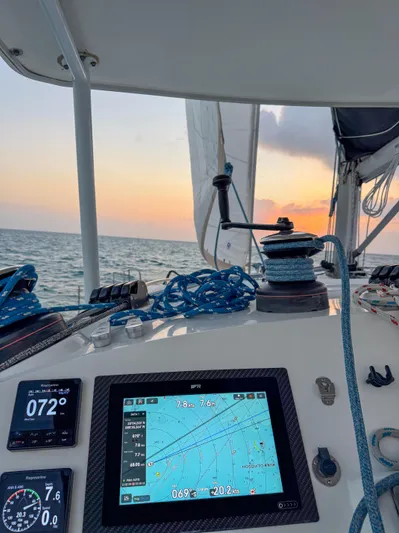 Dao And Out Yacht Photos Pics Sailing on a 2011 Lagoon 400 catamaran at sunset, featuring navigation instruments.