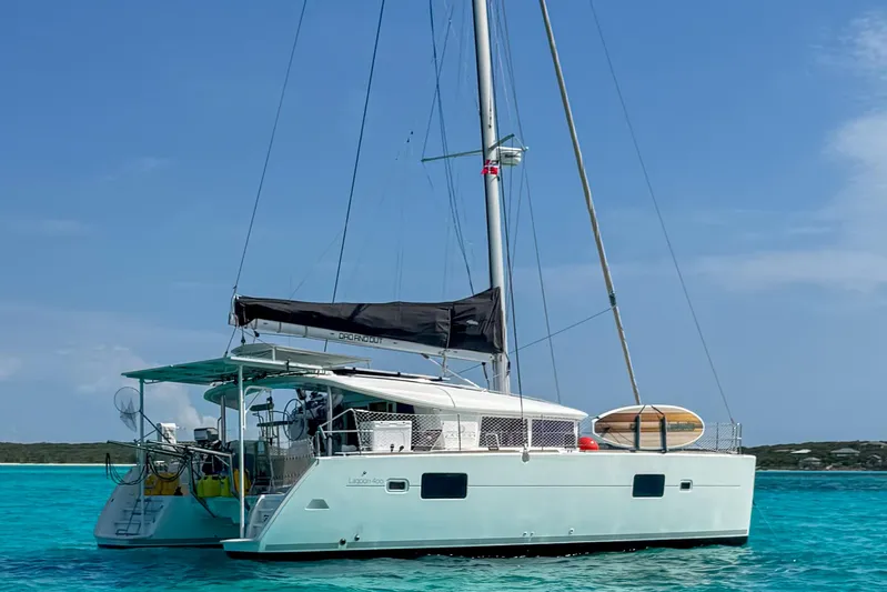 Dao And Out Yacht Photos Pics 2011 Lagoon 400 catamaran sailing on clear turquoise waters under a blue sky.