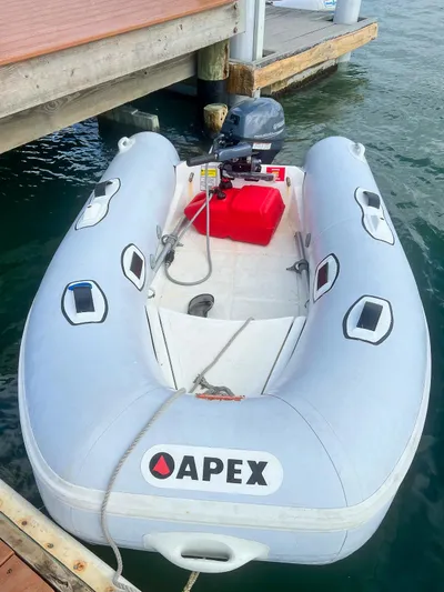 Dao And Out Yacht Photos Pics Inflatable Apex boat docked, featuring an outboard motor and red fuel tank.
