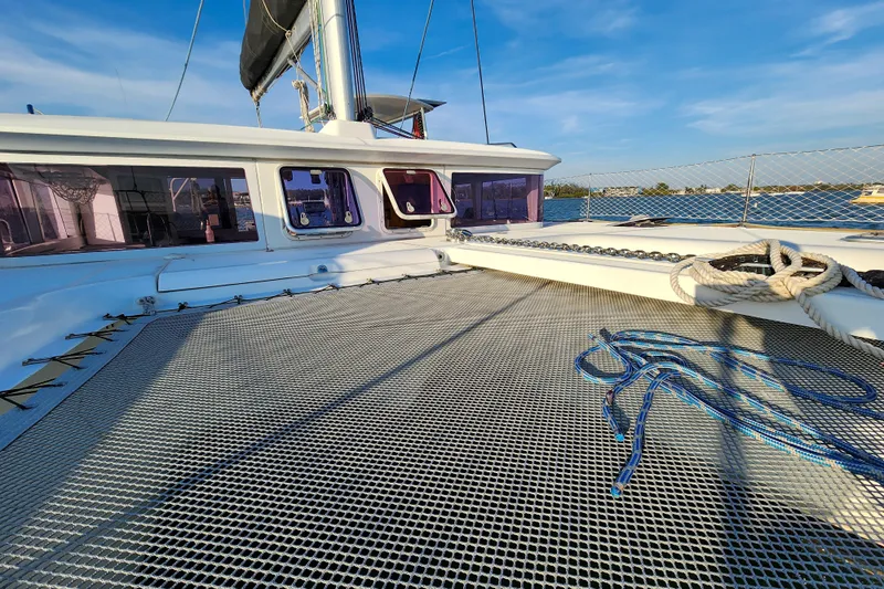 Dao And Out Yacht Photos Pics 2011 Lagoon 400 catamaran deck with netting and ropes under clear blue sky.