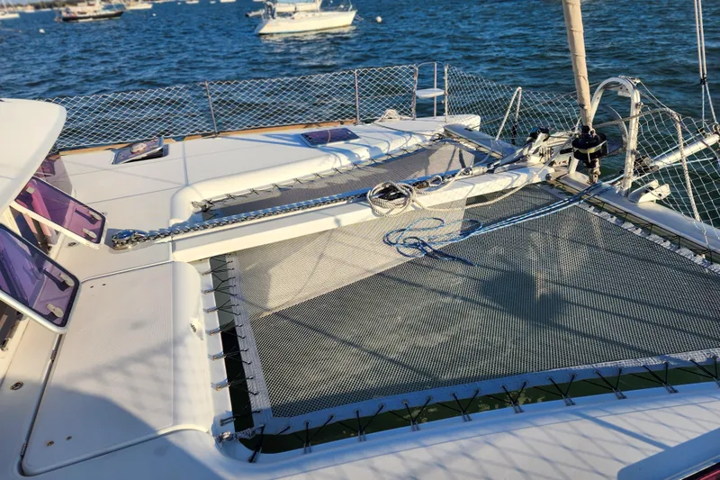 Dao And Out Yacht Photos Pics 2011 Lagoon 400 catamaran deck with netting, moored on a sunny day.