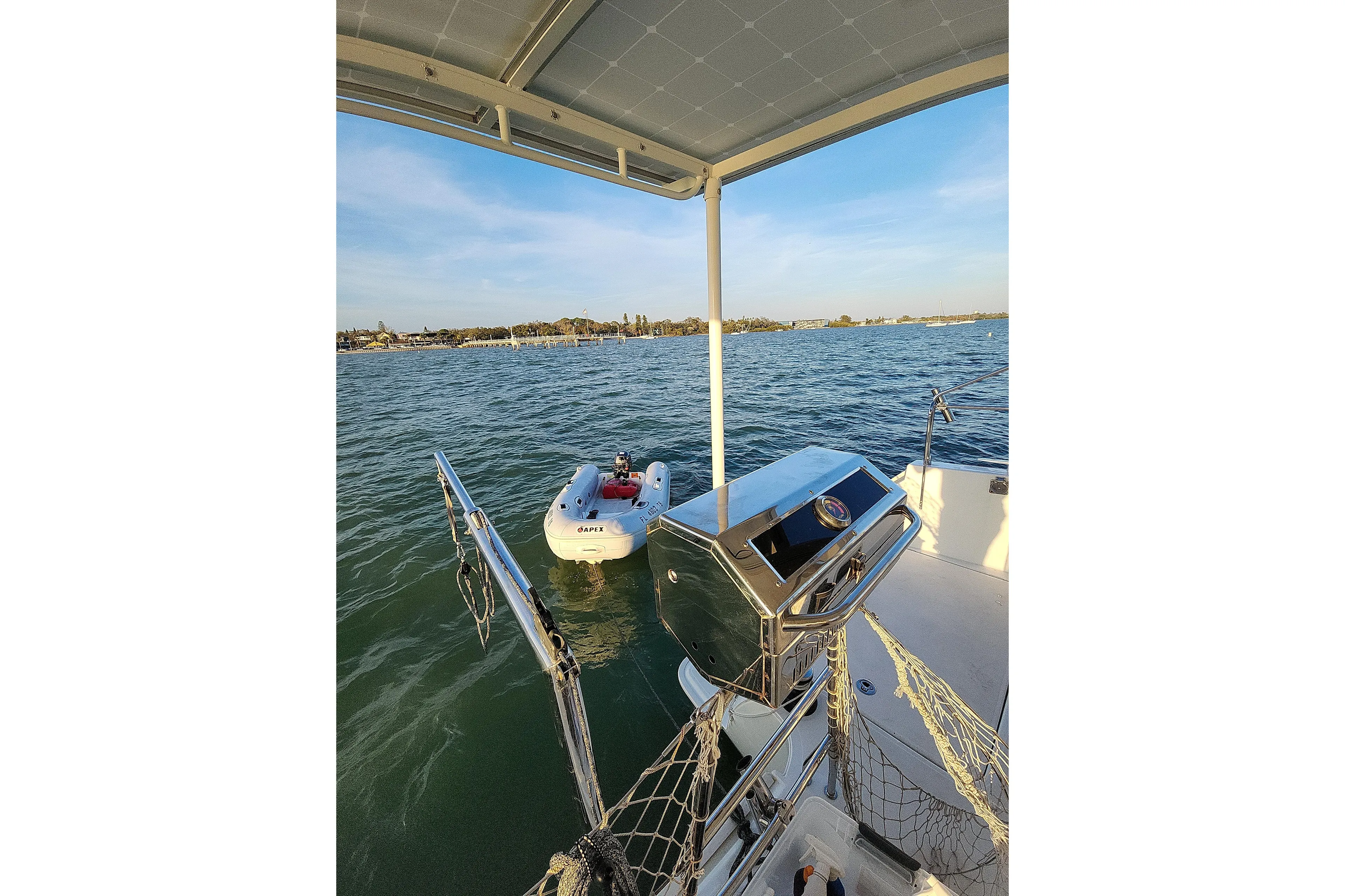 Dao And Out Yacht Photos Pics Lagoon 400 catamaran, 2011 model, with a small dinghy on calm waters.
