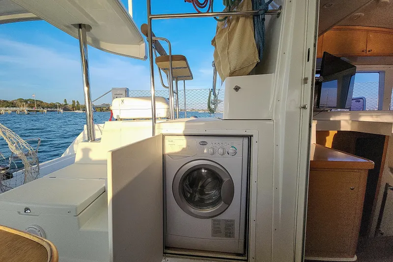 Dao And Out Yacht Photos Pics Lagoon 400 catamaran interior with washing machine, 2011 model, docked by the water.