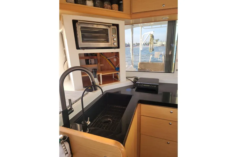 Dao And Out Yacht Photos Pics Modern kitchen in 2011 Lagoon 400 catamaran with sink, oven, and window view.