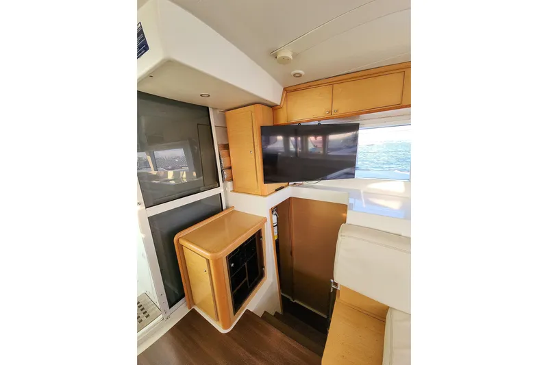 Dao And Out Yacht Photos Pics Interior of 2011 Lagoon 400 yacht with modern wood cabinetry and mounted TV.