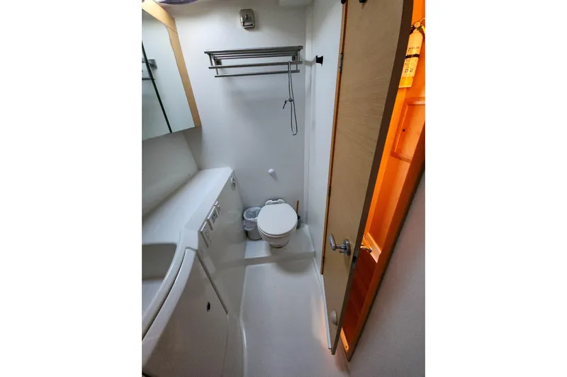 Dao And Out Yacht Photos Pics Compact bathroom in 2011 Lagoon 400 yacht with toilet, sink, and storage.