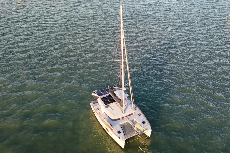 Dao And Out Yacht Photos Pics Aerial view of 2011 Lagoon 400 catamaran sailing on calm waters.