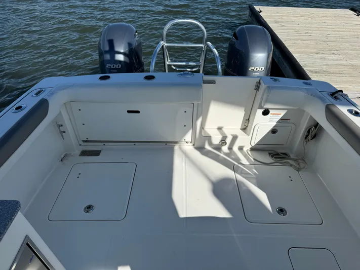 Reel'y Busy Yacht Photos Pics 2020 World Cat 280 DC x boat deck with twin Yamaha 200 engines at dock.