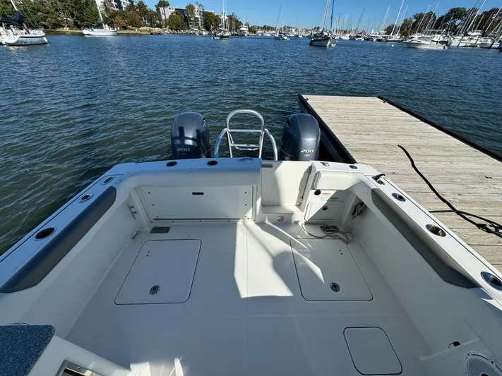 Reel'y Busy Yacht Photos Pics 2020 World Cat 280 DC x boat docked, featuring spacious deck and twin engines.