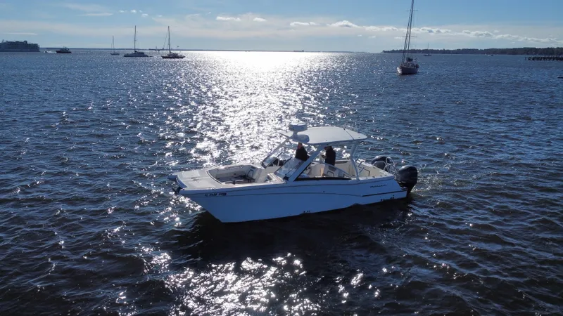 Reel'y Busy Yacht Photos Pics 2020 World Cat 280 DC x boat cruising on a sunny, open sea.