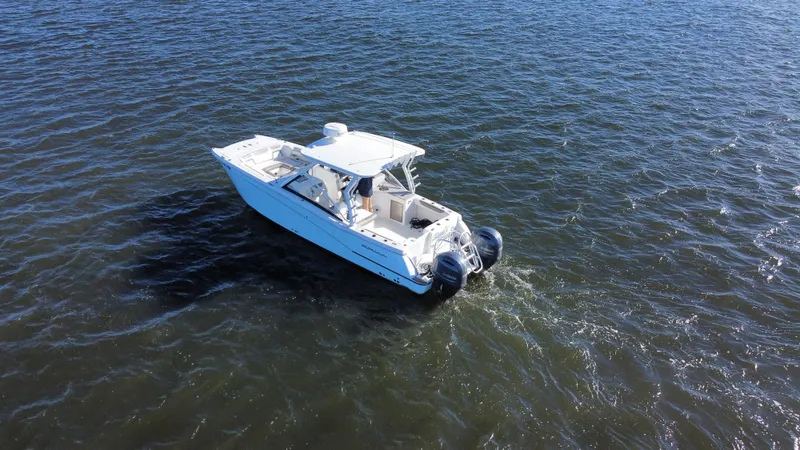 Reel'y Busy Yacht Photos Pics 2020 World Cat 280 DC x boat cruising on open water.