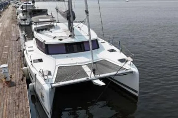 Amihan Yacht Photos Pics 2023 Fountaine Pajot Isla 40 catamaran docked at a marina.