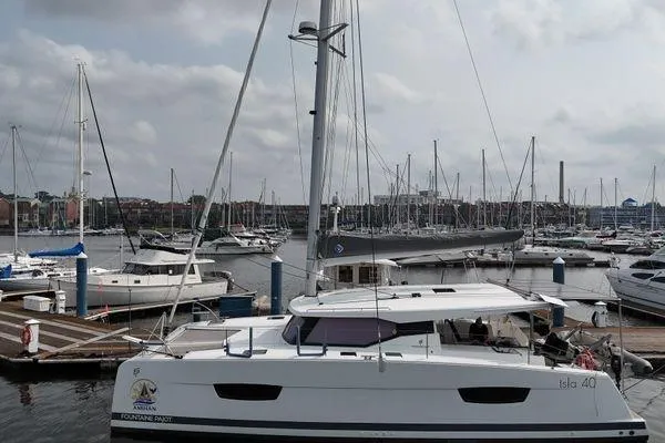 Amihan Yacht Photos Pics 2023 Fountaine Pajot Isla 40 catamaran docked in a marina with other boats.