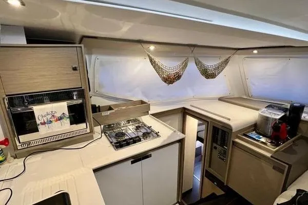 Amihan Yacht Photos Pics Modern kitchen interior of 2023 Fountaine Pajot Isla 40 catamaran with appliances and storage.