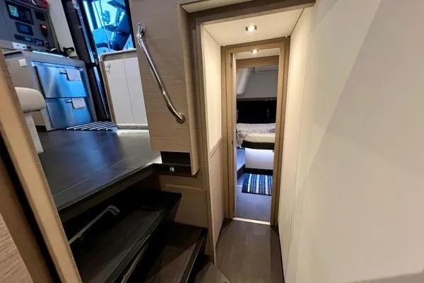 Amihan Yacht Photos Pics 2023 Fountaine Pajot Isla 40 interior hallway with modern design and cozy bedroom view.