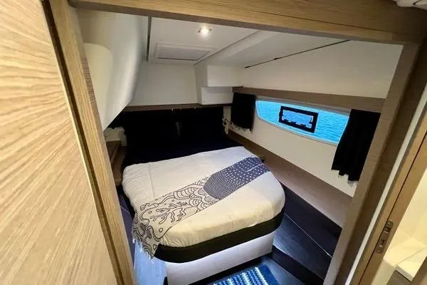 Amihan Yacht Photos Pics Luxurious cabin interior of 2023 Fountaine Pajot Isla 40 catamaran with cozy bed and window view.