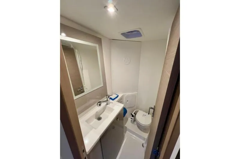 Amihan Yacht Photos Pics Bathroom interior of 2023 Fountaine Pajot Isla 40 catamaran, featuring sink and toilet.